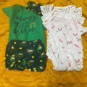 Assorted seasonal and non-seasonal baby clothes.